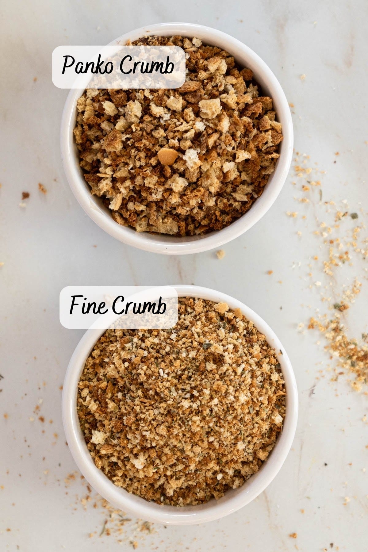Two bowls of gluten free bread crumbs, one a coarse texture labeled panko and one fine textured,.