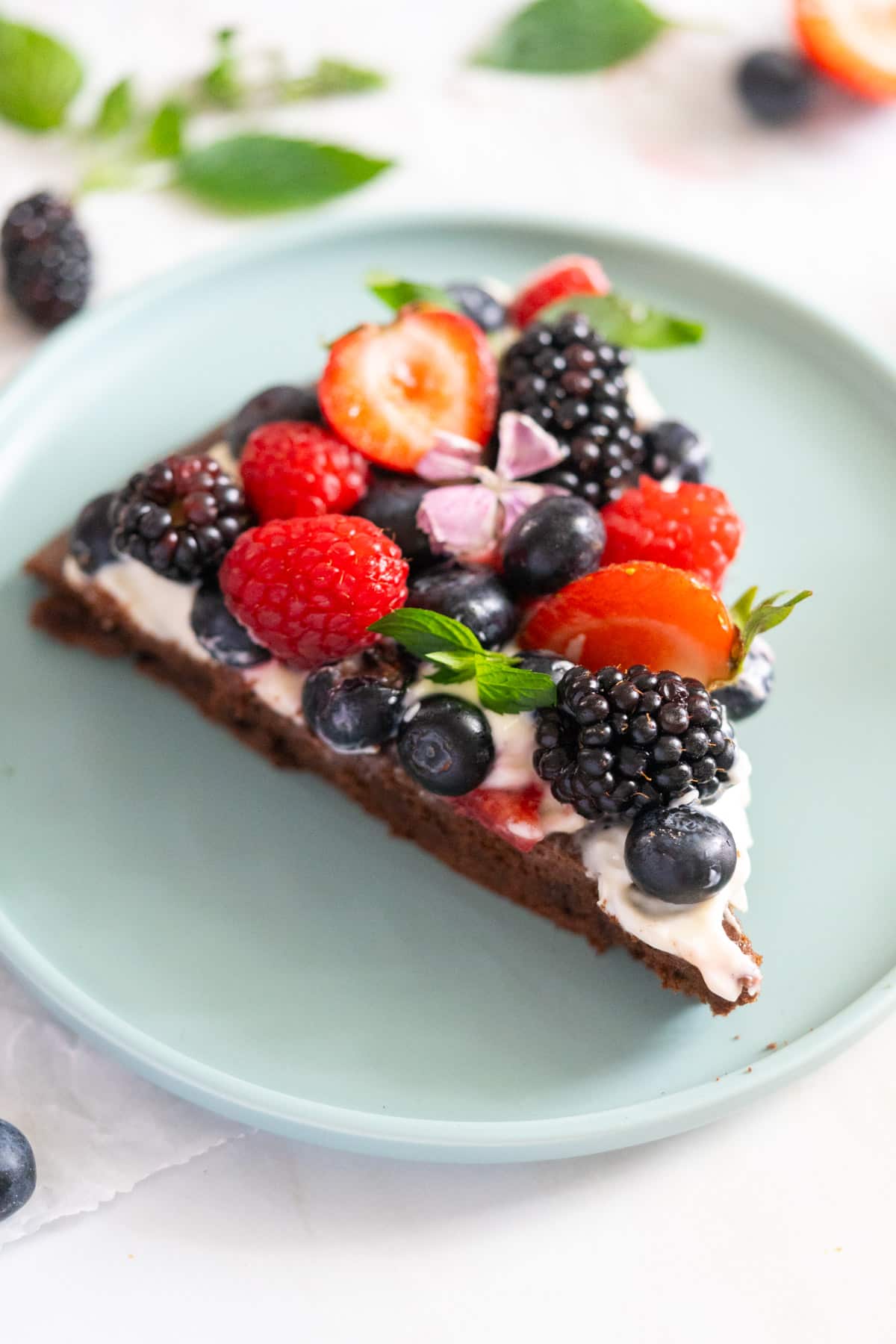 A slice of brownie pizza on a plate.