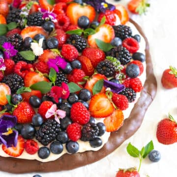 Gluten free dessert pizza with cream cheese frosting and fresh berries.