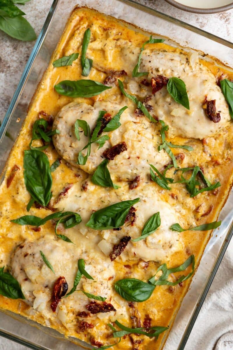 Tuscan chicken with sun dried tomatoes in a cream sauce with fresh basil leaves.