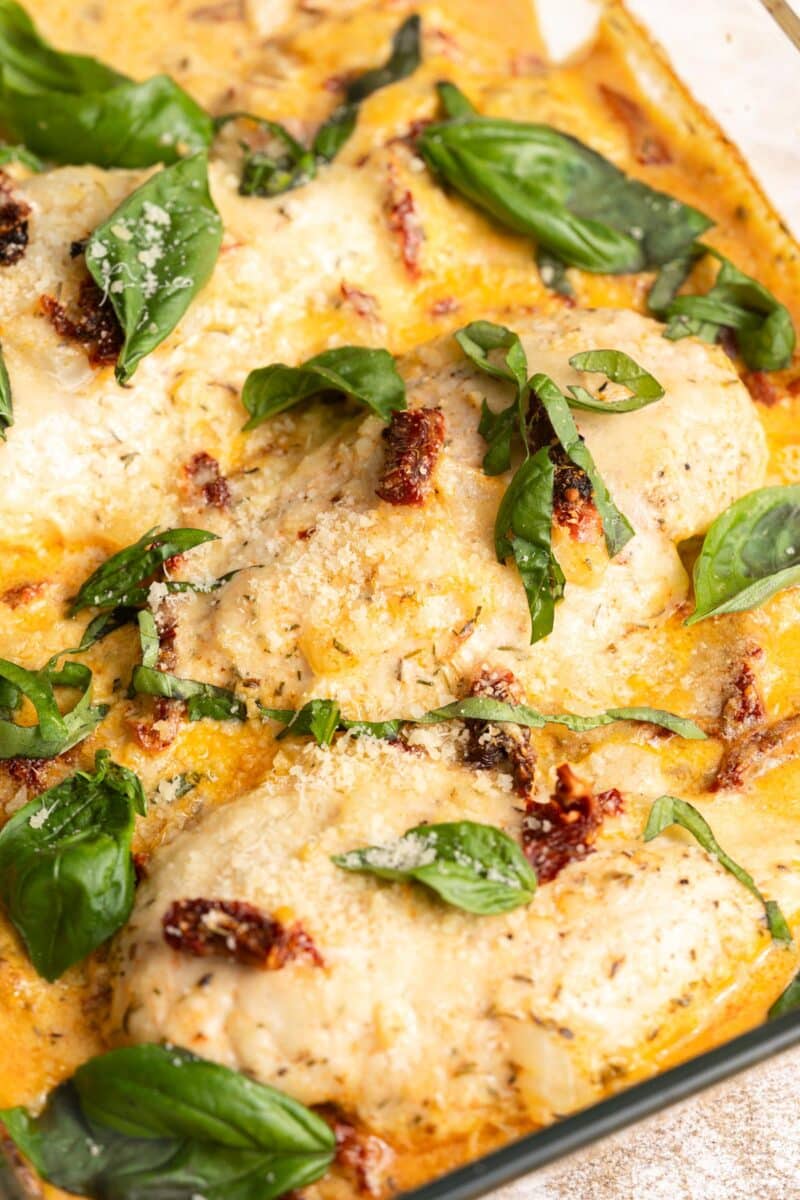 Chicken breast with sun dried tomatoes in a cream sauce with fresh basil leaves.