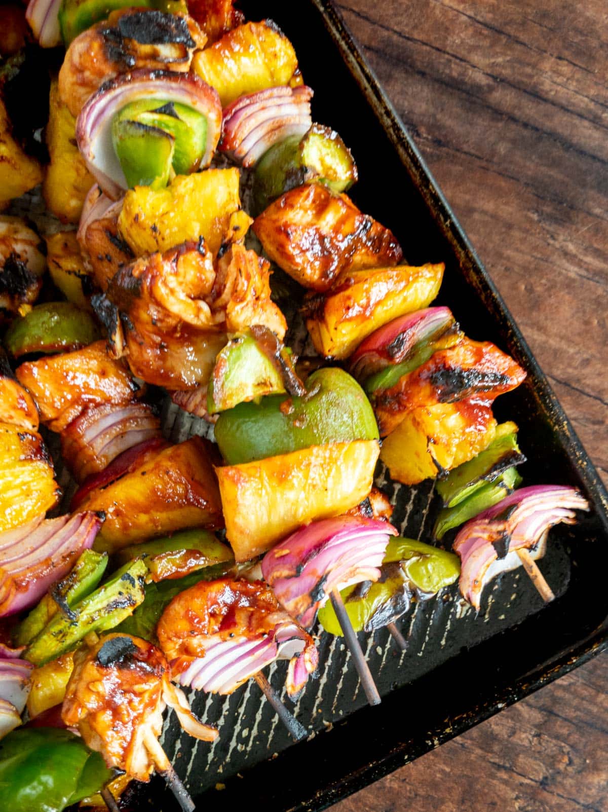 Chicken skewers on a baking sheet.