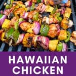 Chicken skewers with pineapple and bell pepper on a grill.