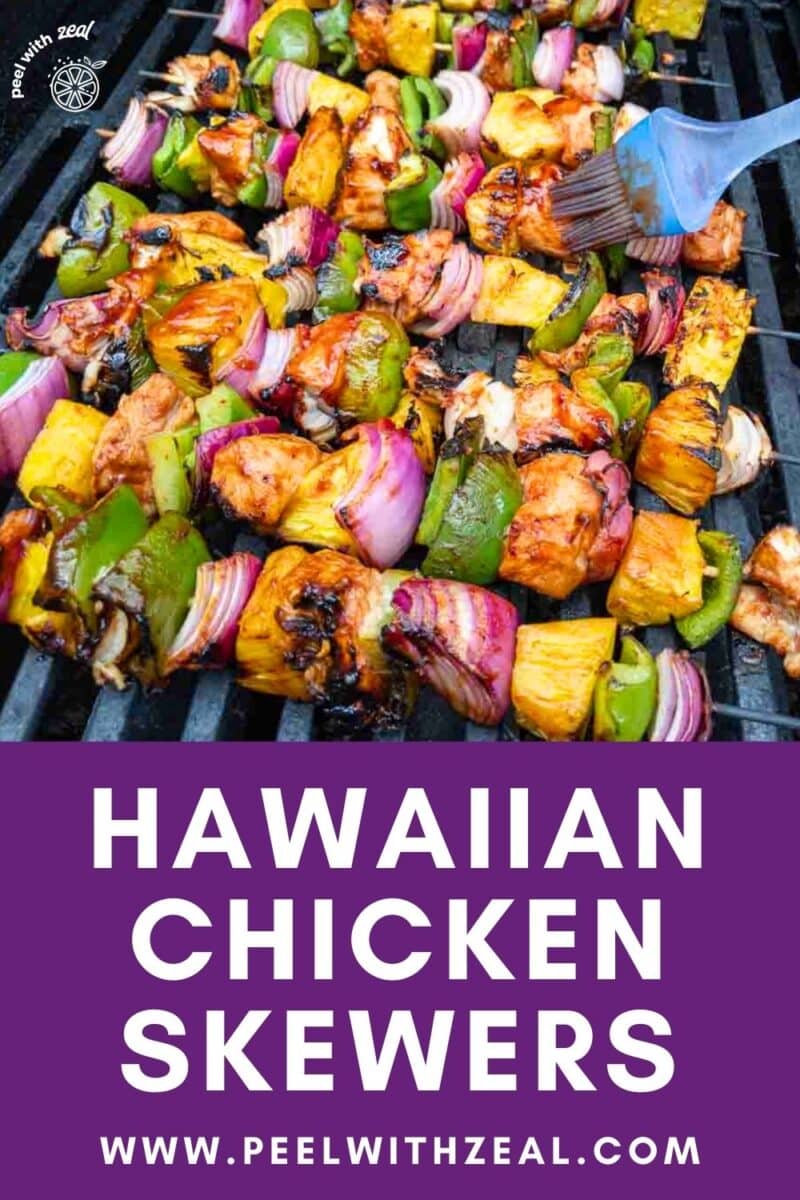 Chicken skewers with pineapple and bell pepper on a grill.