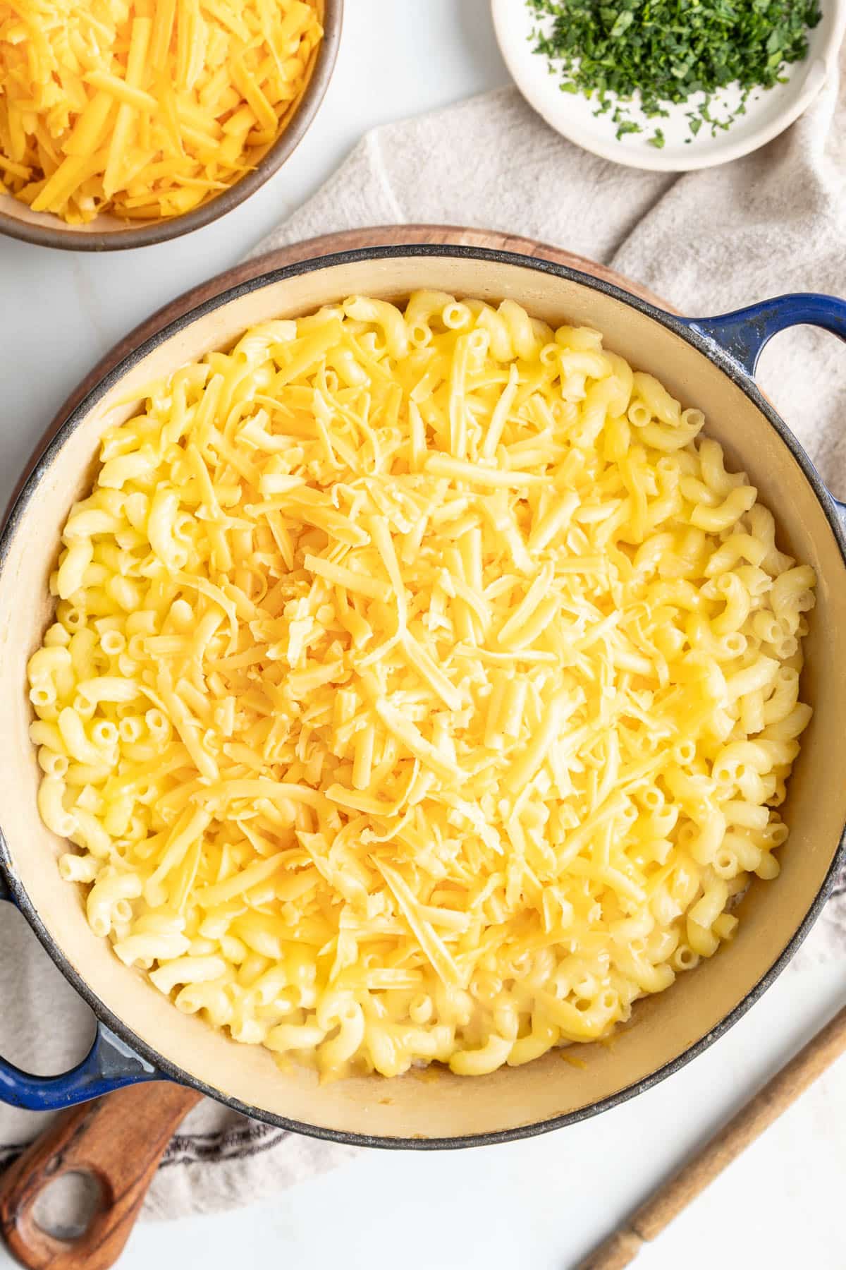 Add shredded cheese to the noodles.