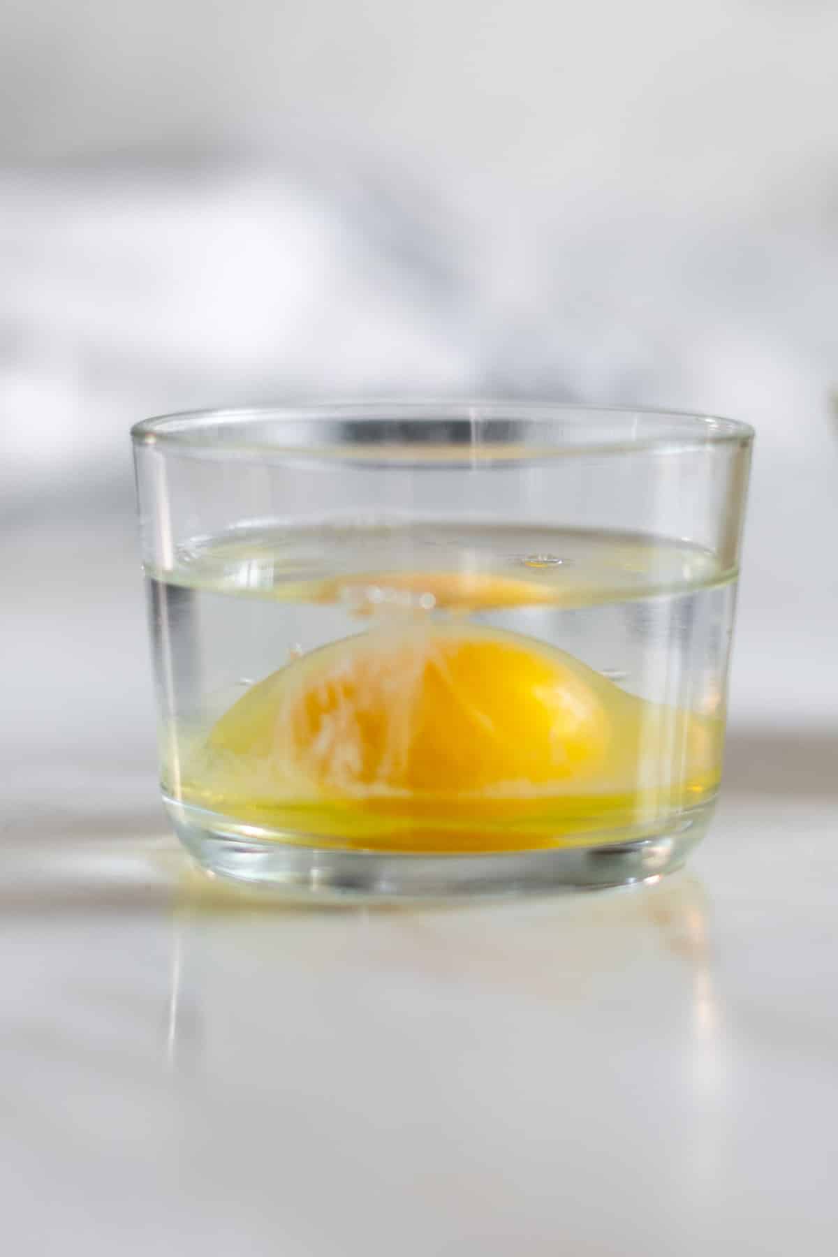 Raw egg in glass bowl with 1 inch of water.