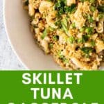 Skillet tuna casserole in a bowl with peas and parsley.