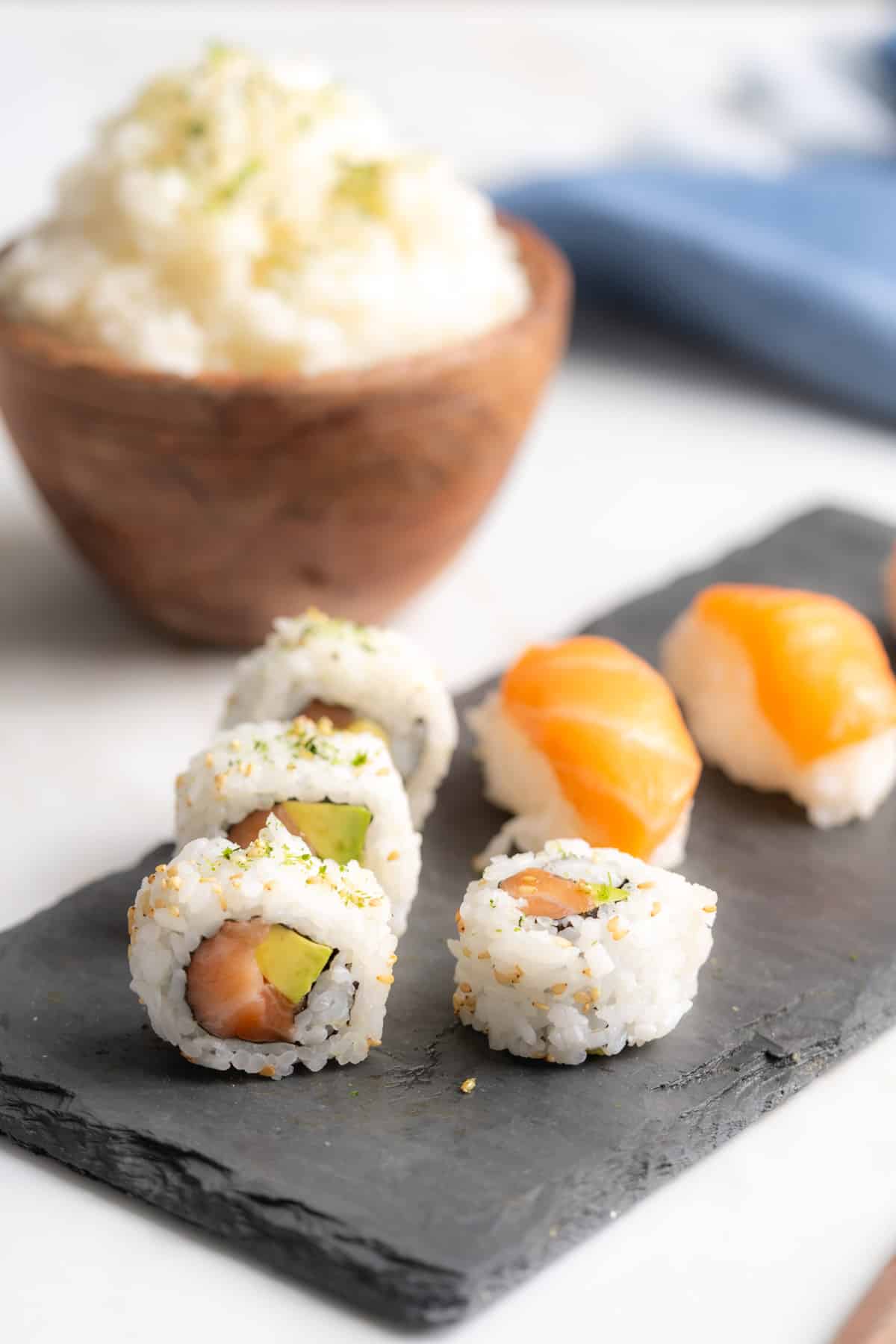 Salmon sushi rolls and nigiri on a tray.