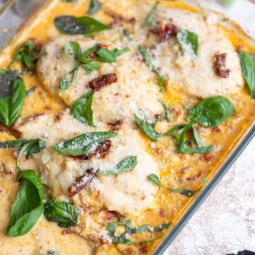 Tuscan chicken with sun dried tomatoes in a cream sauce with fresh basil leaves.