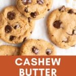 Chocolate chip cashew butter cookies on parchment paper.