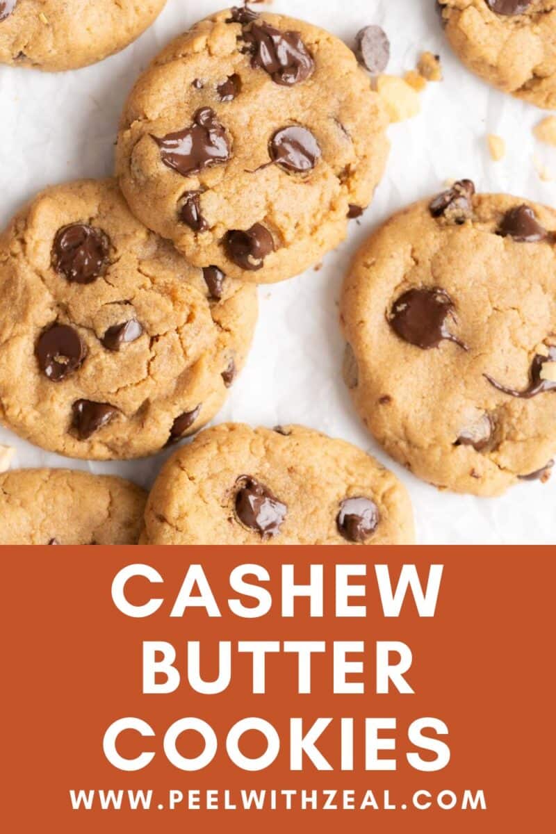 Chocolate chip cashew butter cookies on parchment paper.