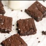 Gluten free brownies on white parchment paper.