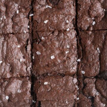 Gluten free brownies cut into squares and topped with sea salt.