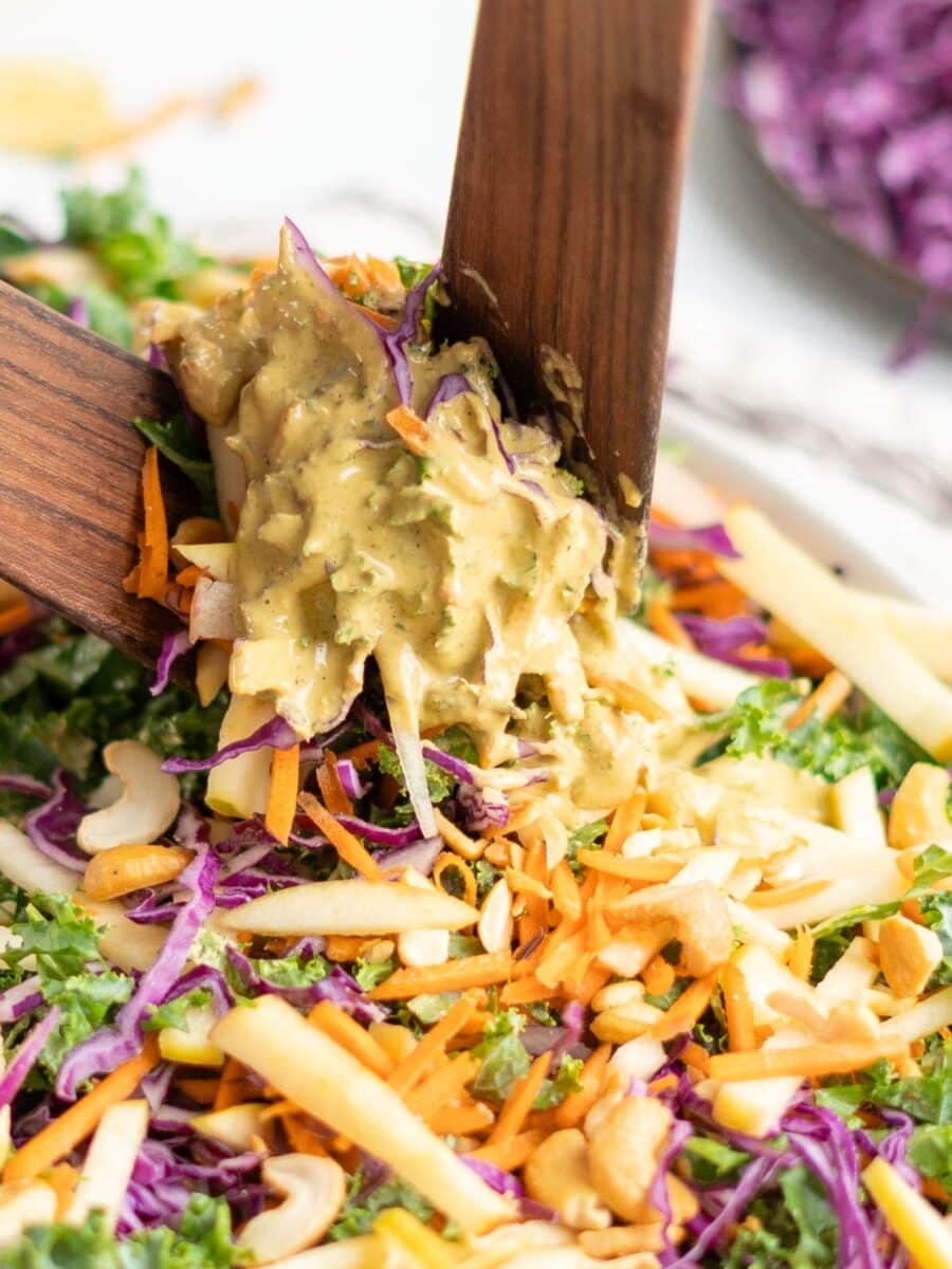 Tossing slaw in dressing.
