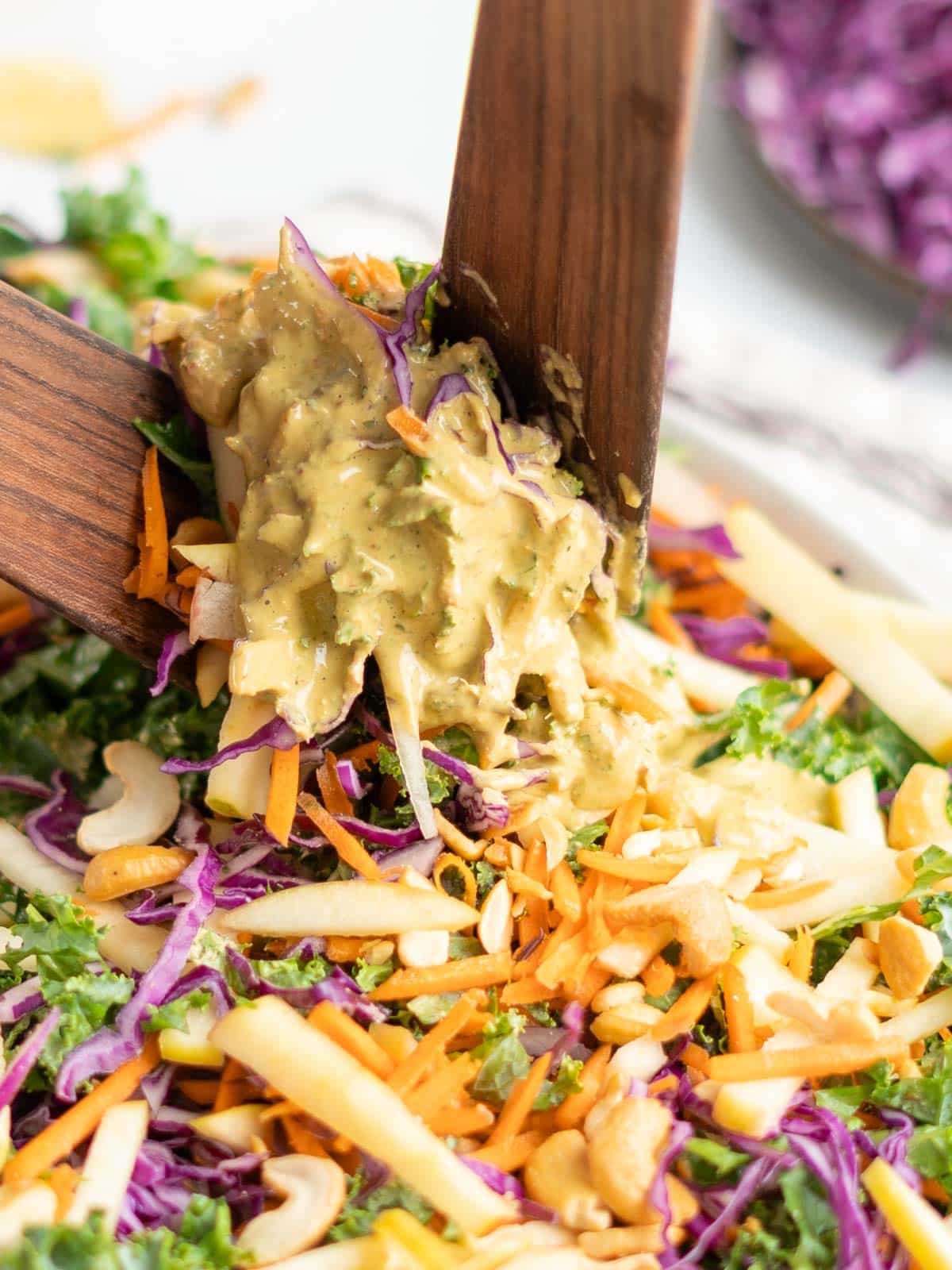 Tossing slaw in dressing.