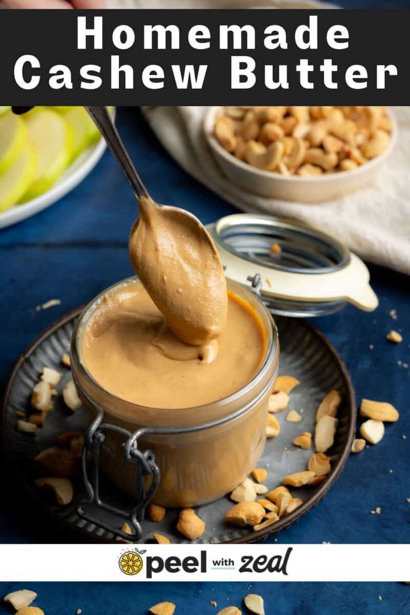 Spooning cashew butter into a jar.