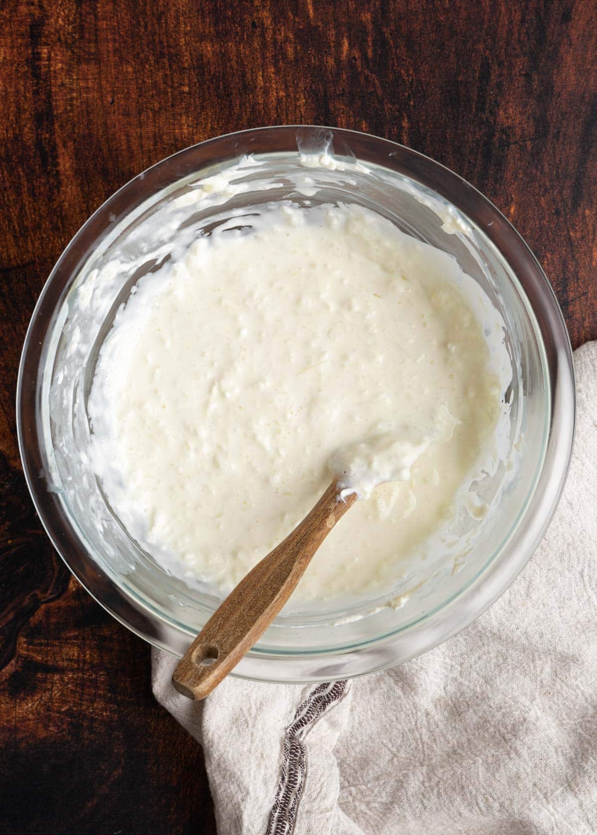 Stirring the dip in a small mixing bowl.