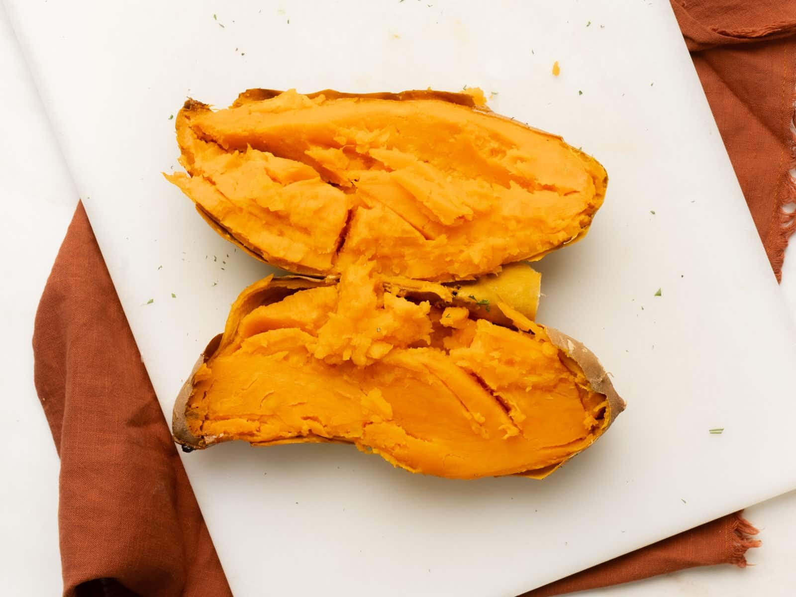 Roasted sweet potato cut in half.