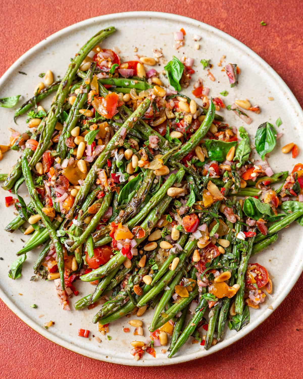 Charred green beans served on a plate.