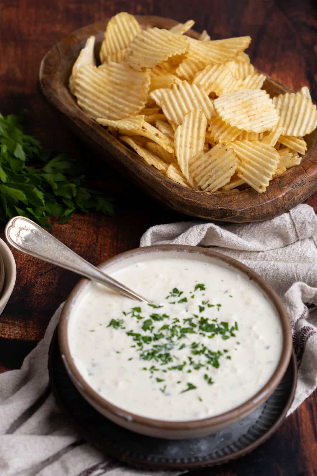 Dipping a potato chip into cream cheese onion dip.