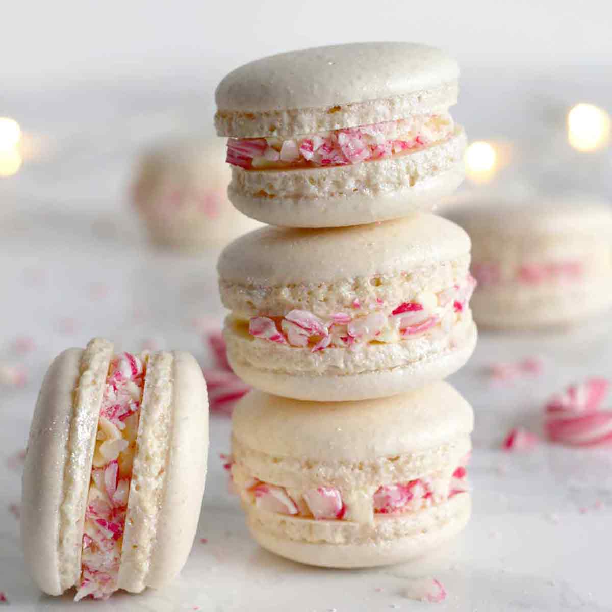 Vegan Christmas macarons stacked on top of one another.