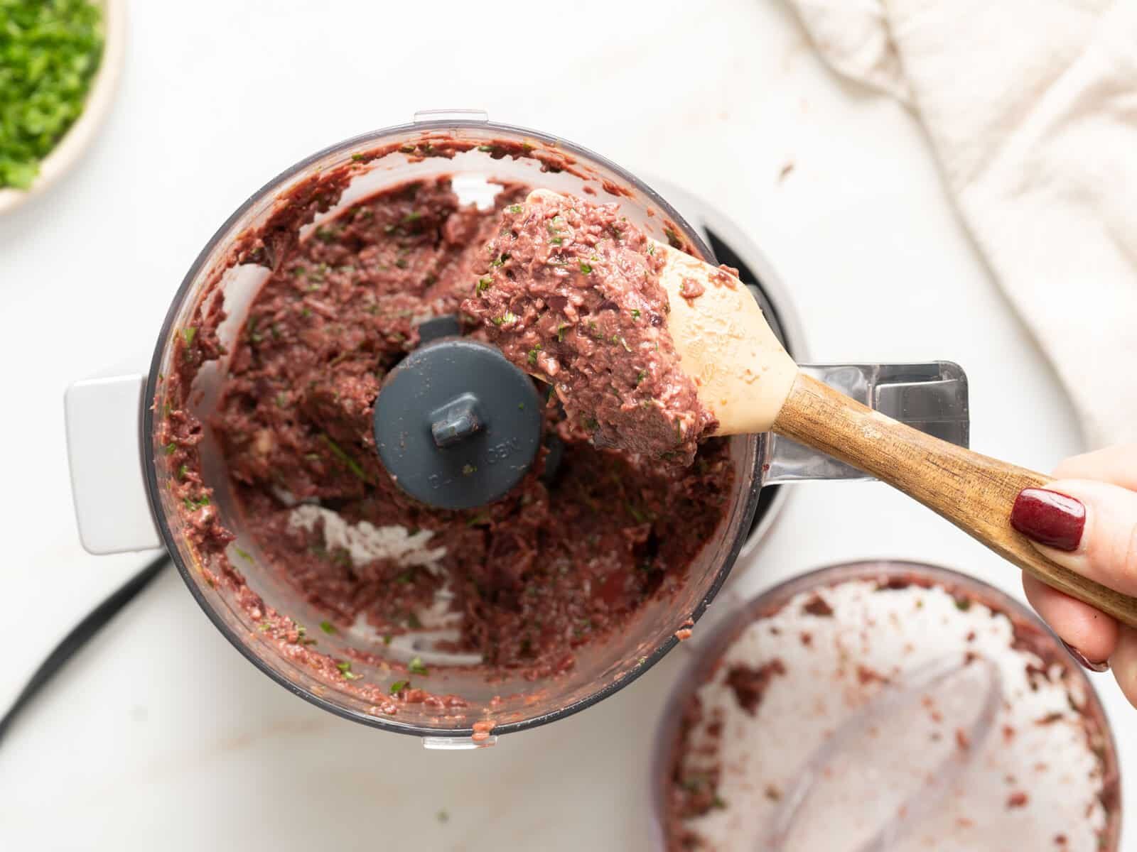 tapenade ingredients in a food processor with a smoother texture.