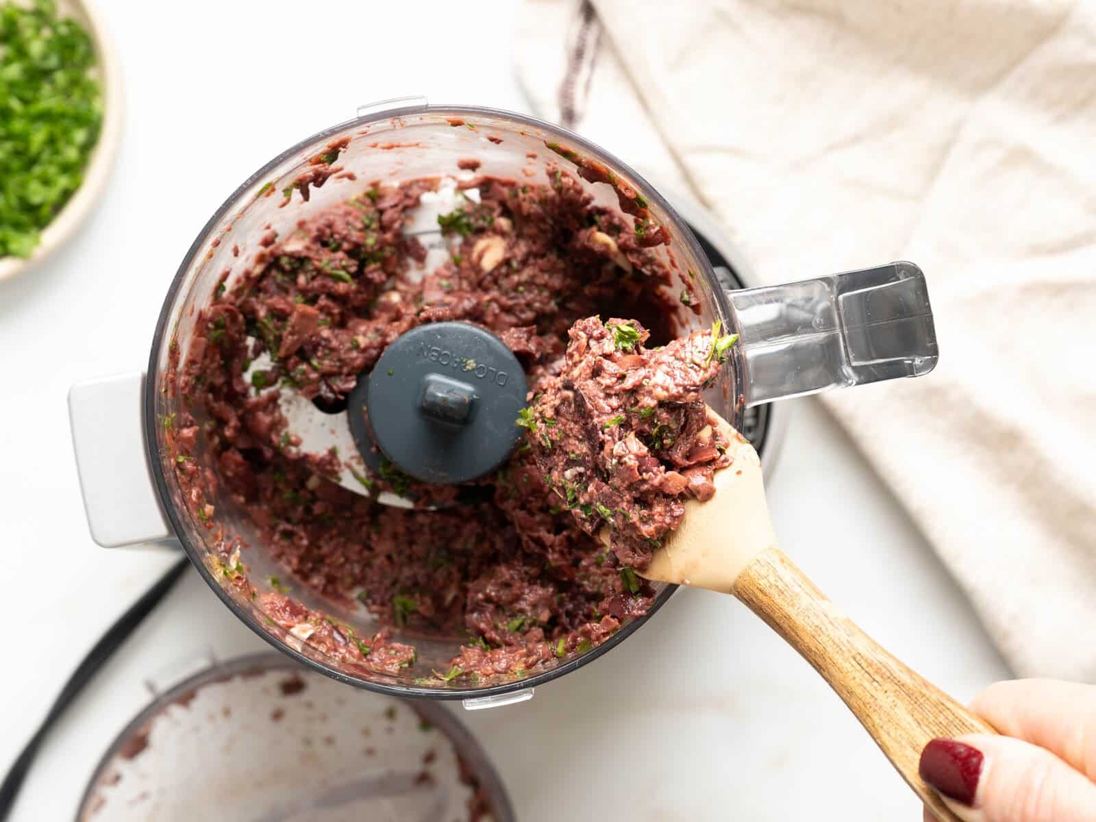 Kalamata olives tapenade ingredients in a food processor.