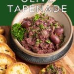 Kalamata olive tapenade in a bowl with wooden spoon.