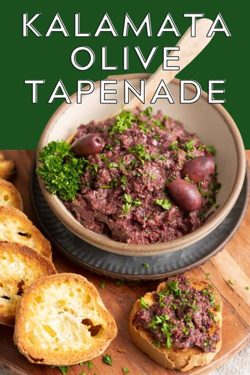 Kalamata olive tapenade in a bowl with wooden spoon.