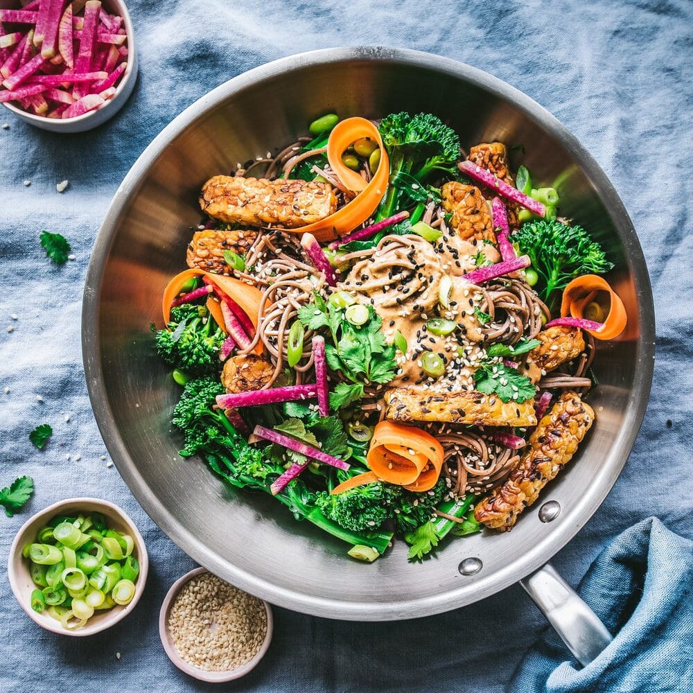 Cashew soba noodle salad with watermelon radish in a bowl.