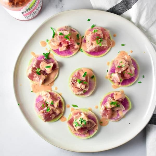 Spicy tuna on top of watermelon radish slices.