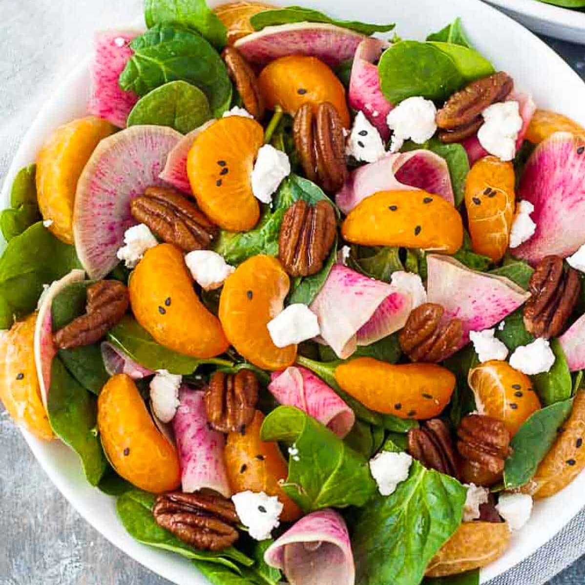 Watermelon radish with orange and pecans.