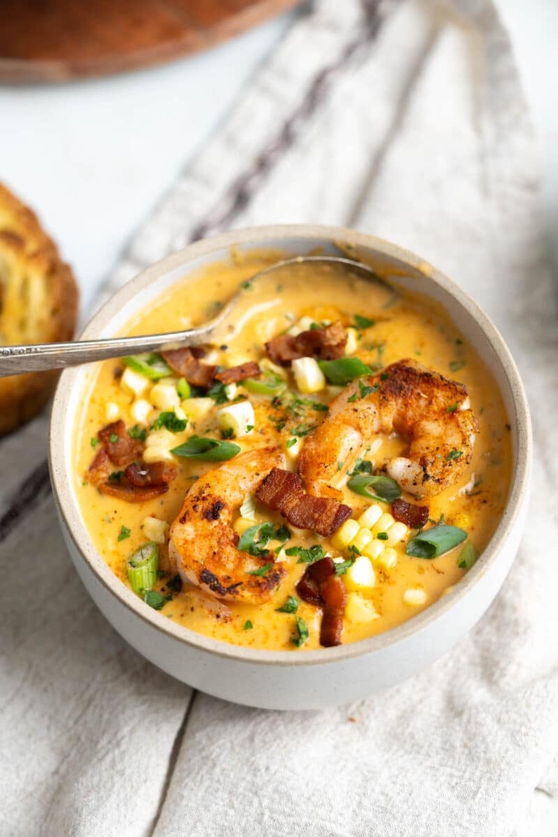 A bowl of shrimp bisque with spoon.