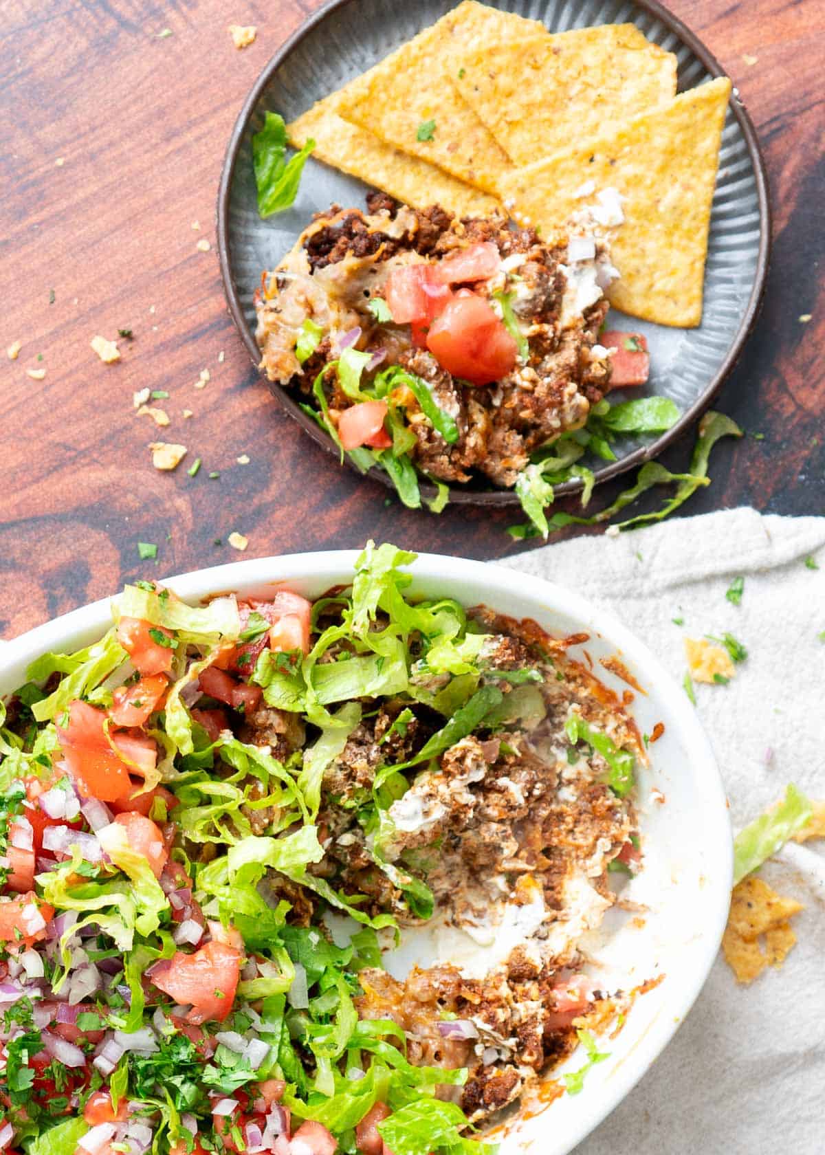 Beef taco dip with sides of chips.