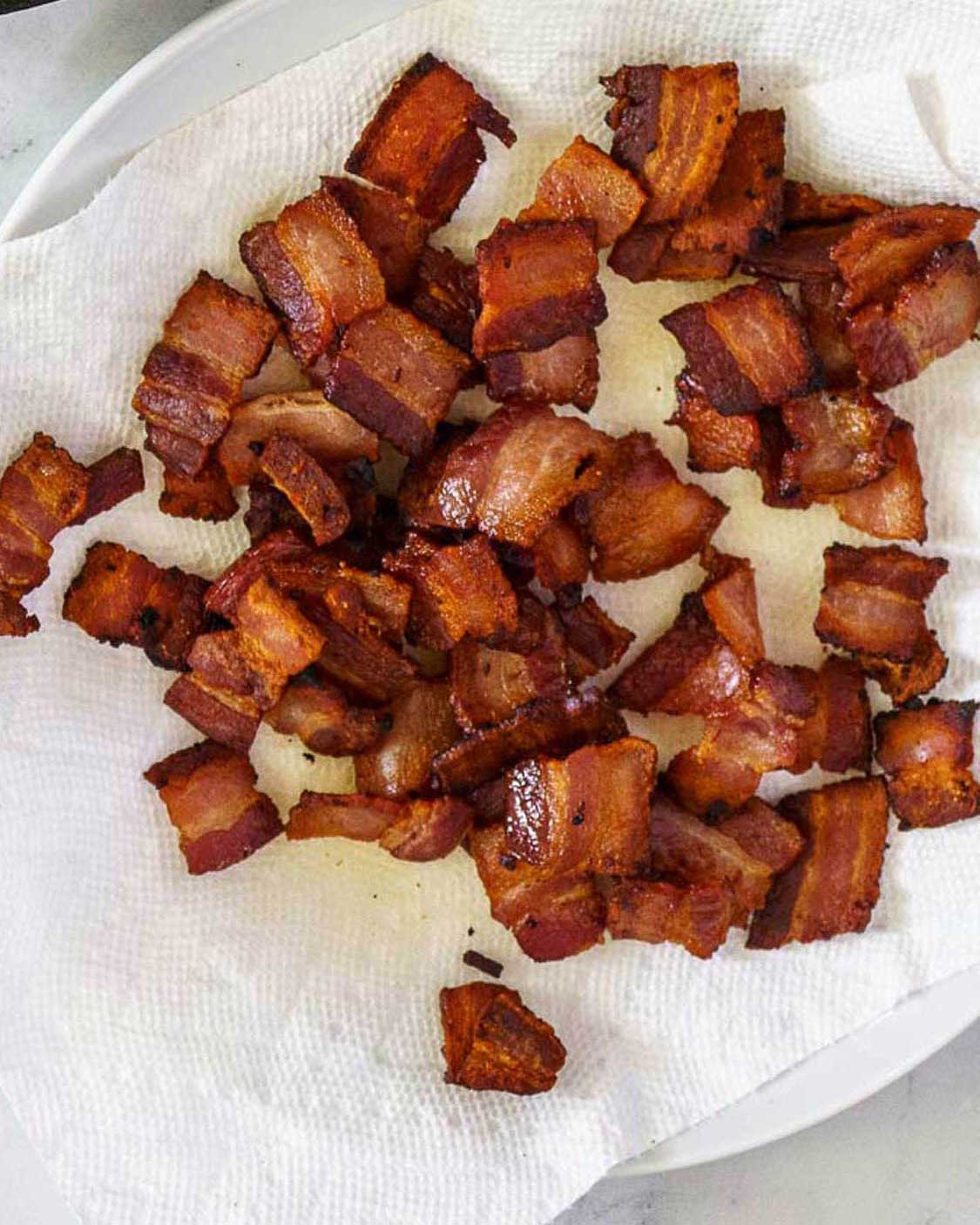 Cooked bacon on a paper towel.