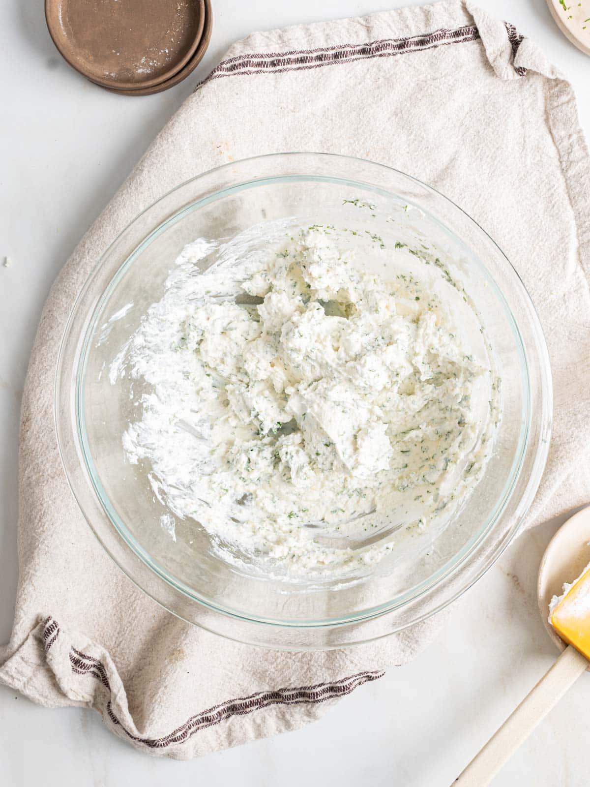 Spinach artichoke dip ingredients in a bowl.