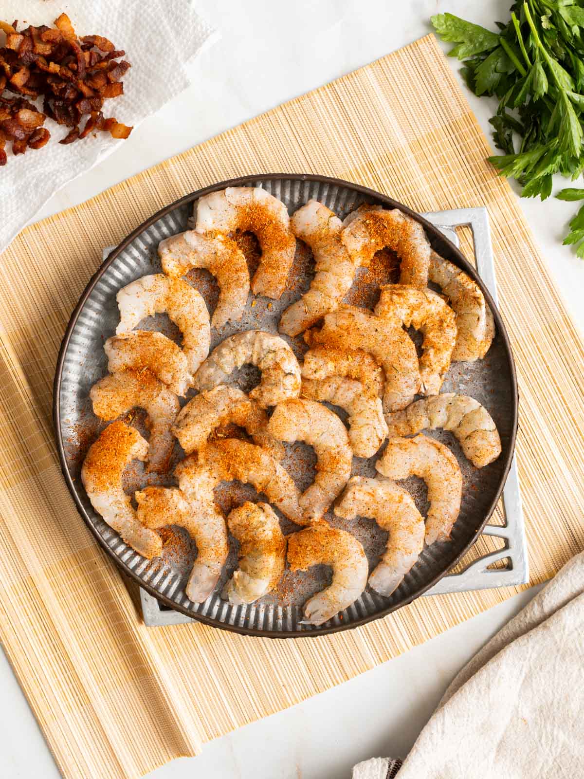Peeled and seasoned shrimp on a plate.