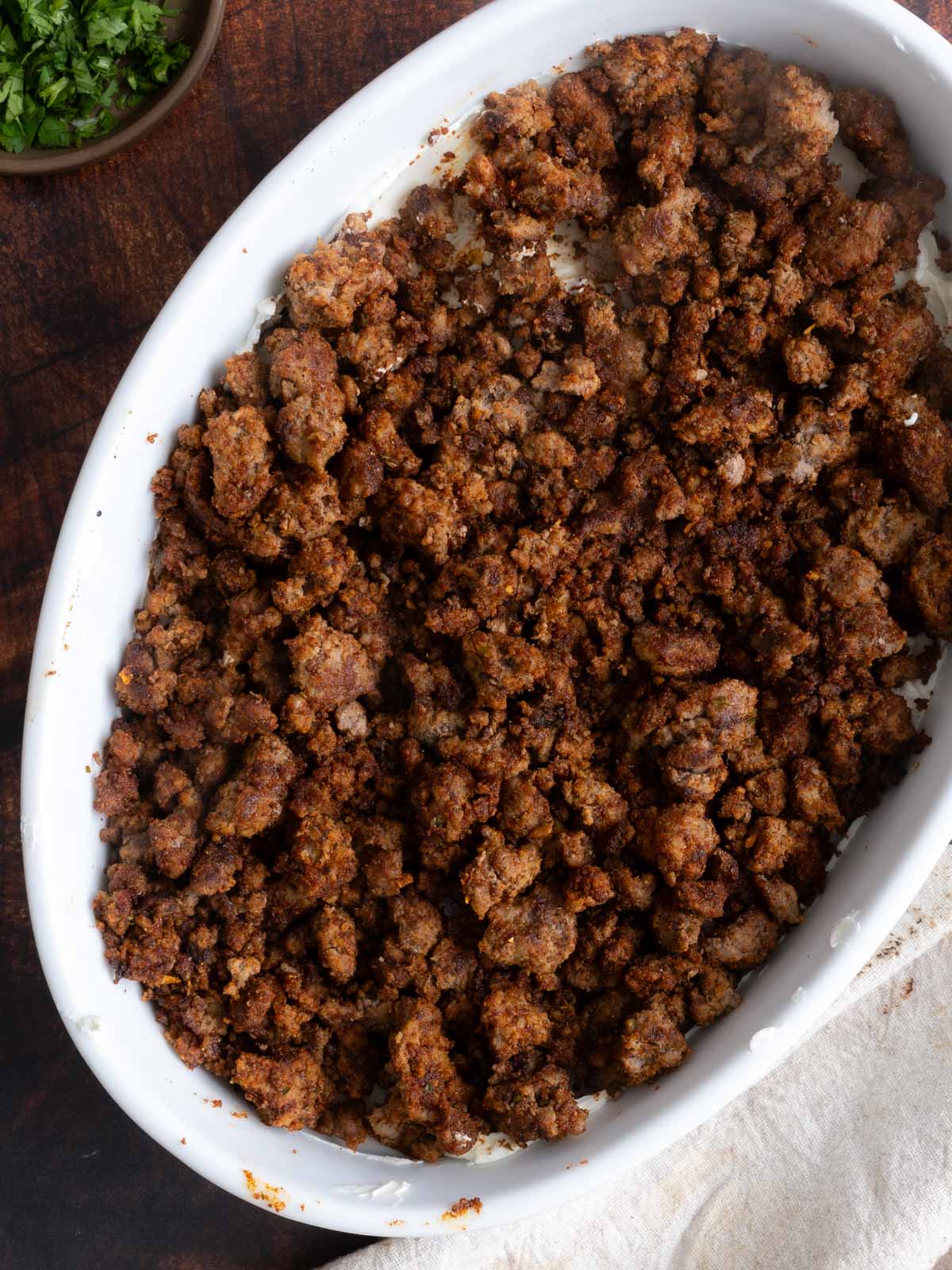 Taco meat layer in a baking dish.