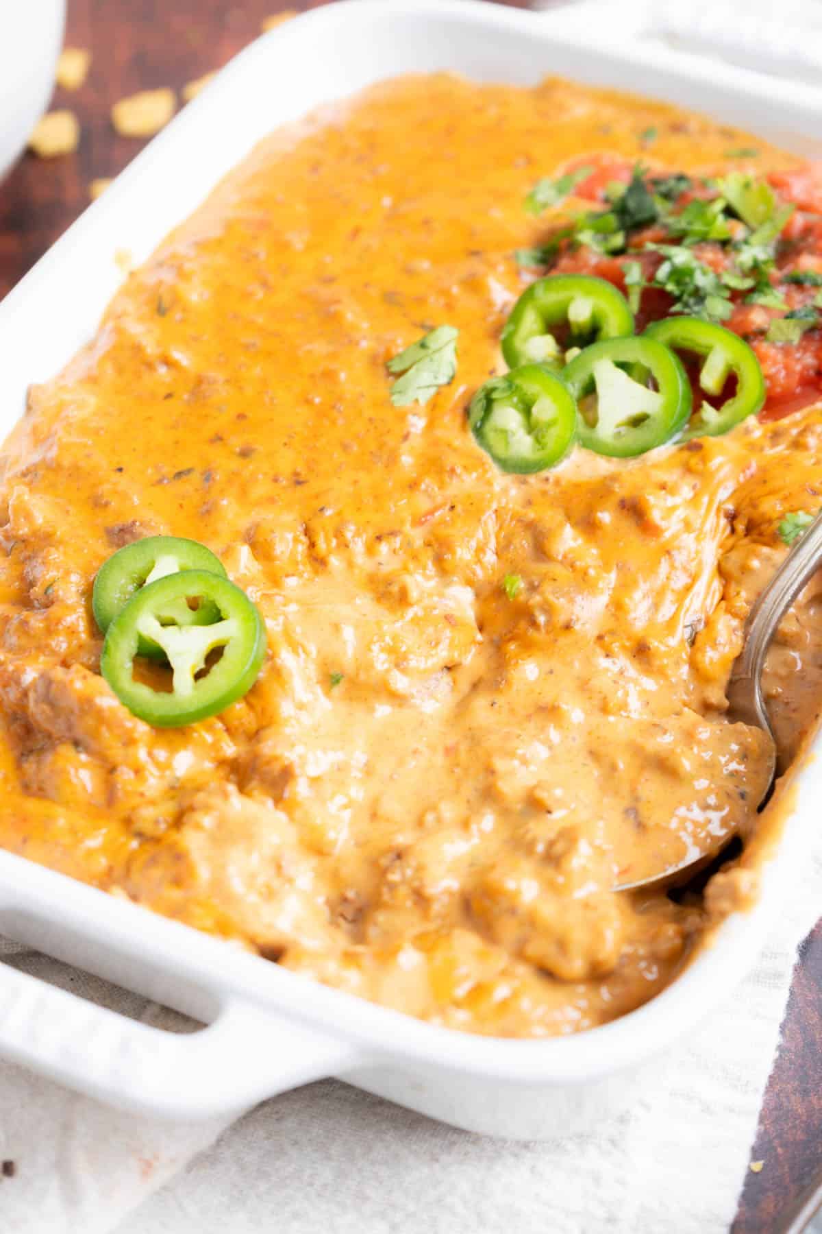 Velveeta dip in a dish with a silver spoon.