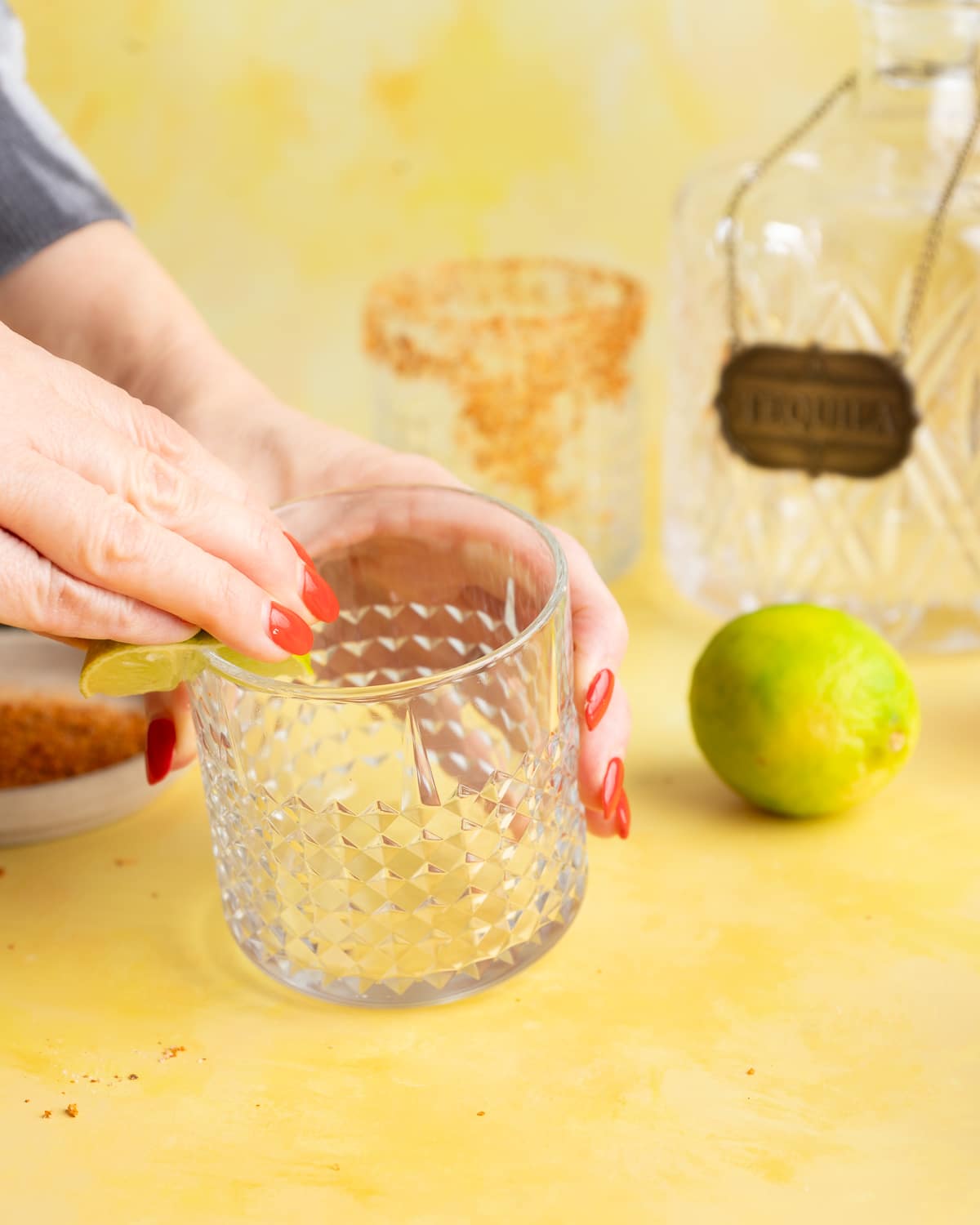 Lime squeezed at the rim of a glass.