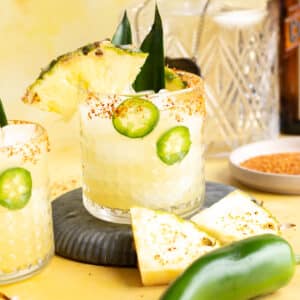 A glass of pineapple margarita with jalapeno syrup.