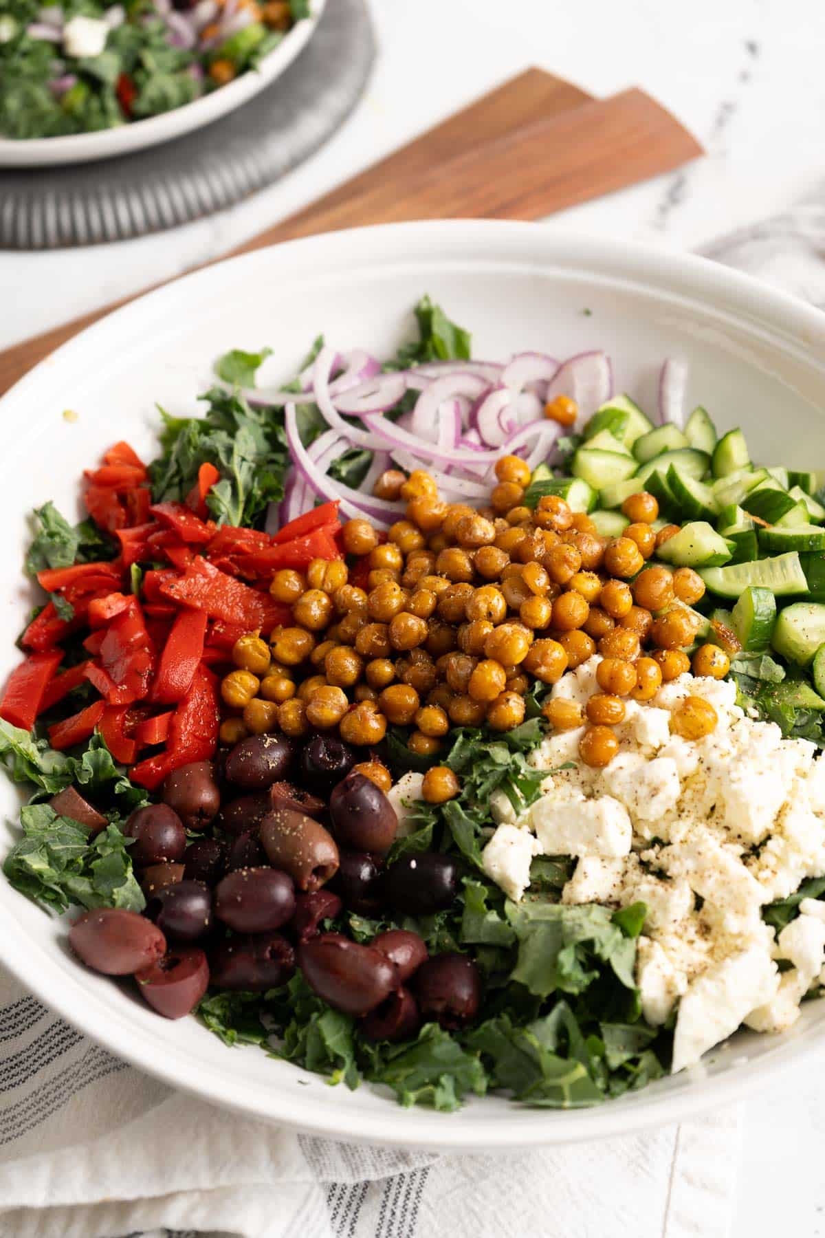 Greek kale salad with fetta cheese in a bowl.