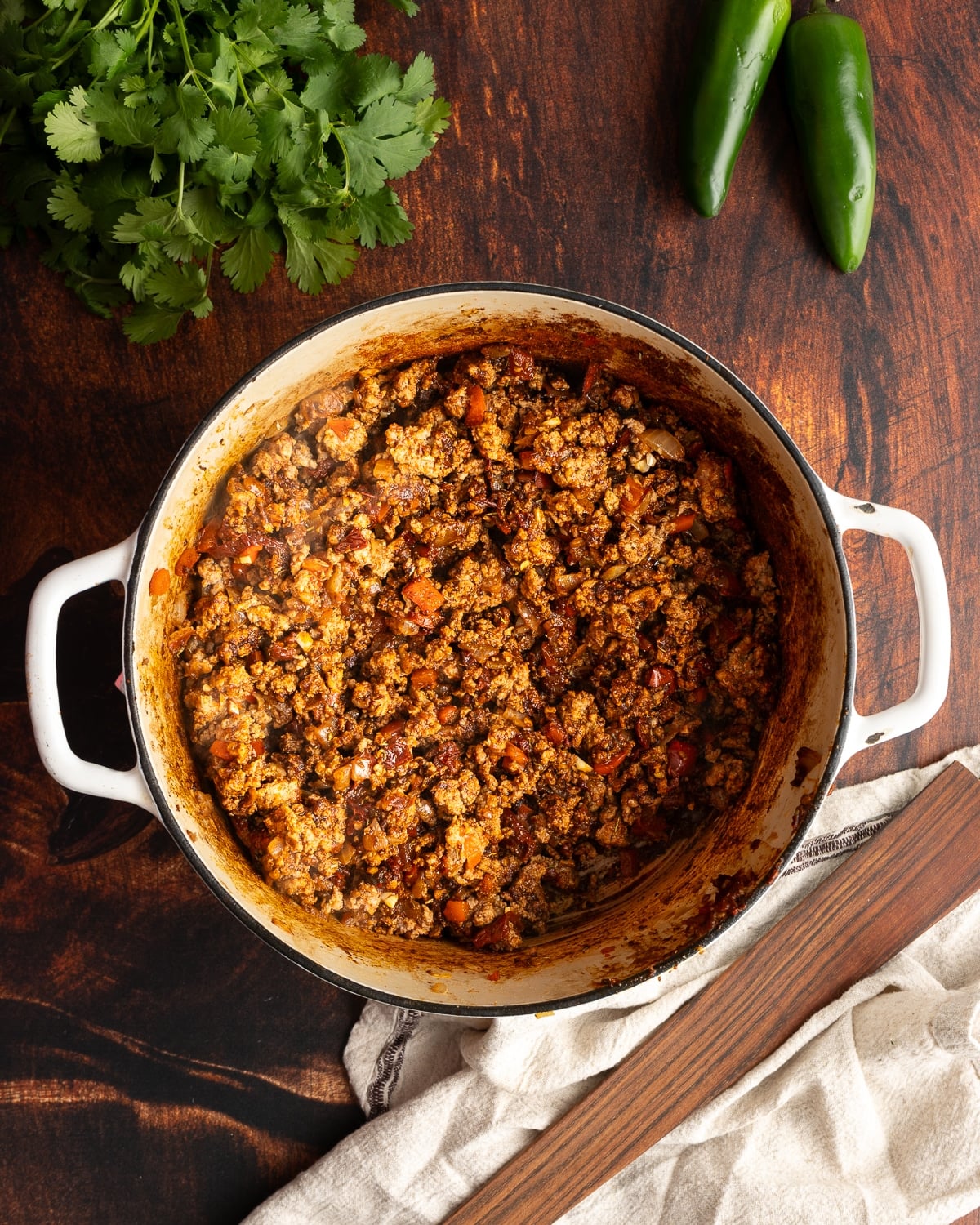 Cooked turkey meat with onion and peppers in a pot.
