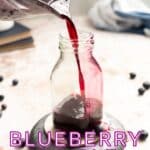 Blueberry syrup in a glass bottle.