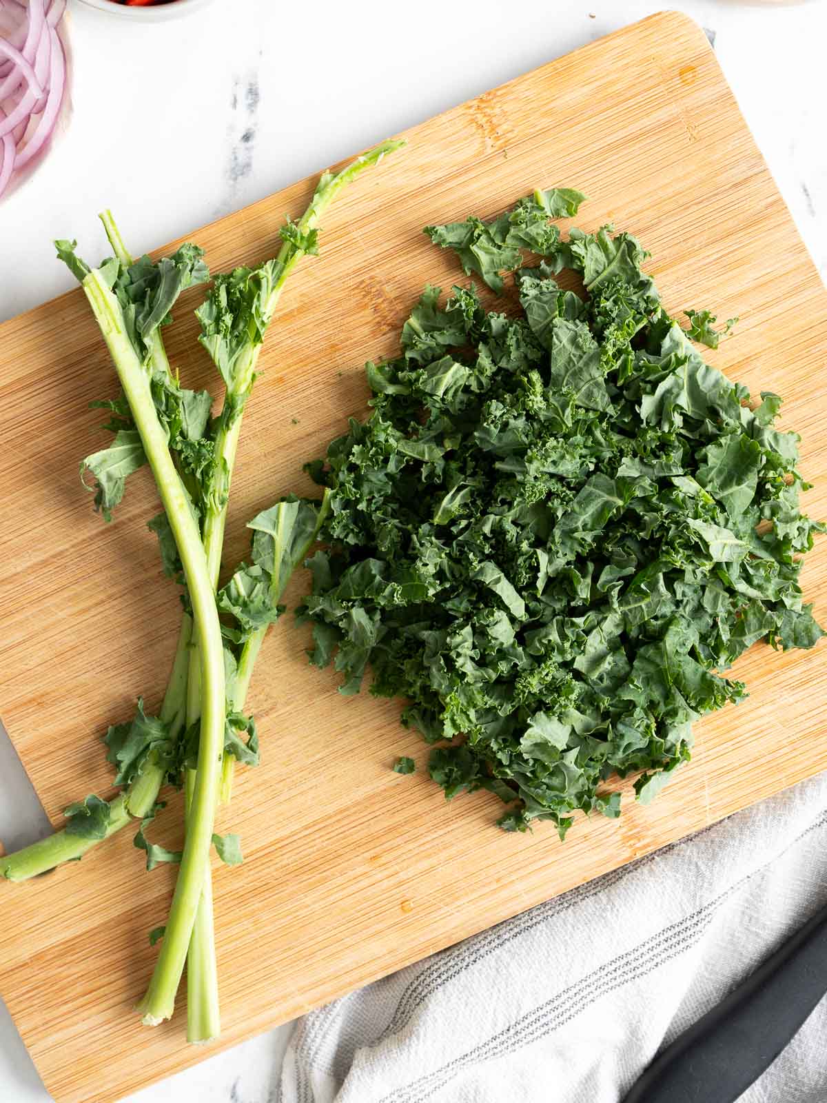 Shredded kale on top of a chopping board.