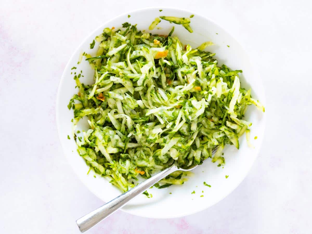 cucumber chutney being mixed in bowl.
