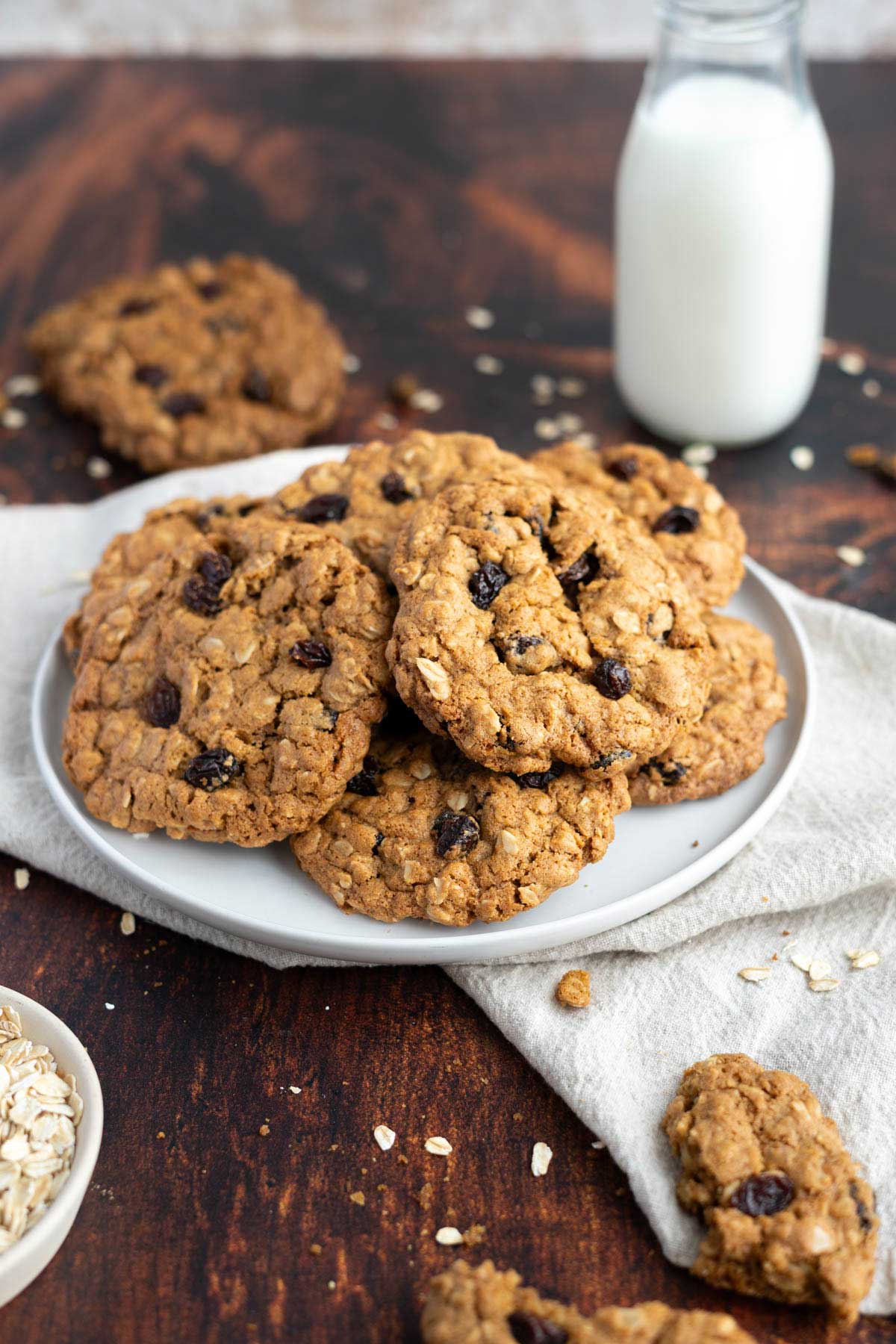 oatmeal cookies on a plate with a glass of milk.