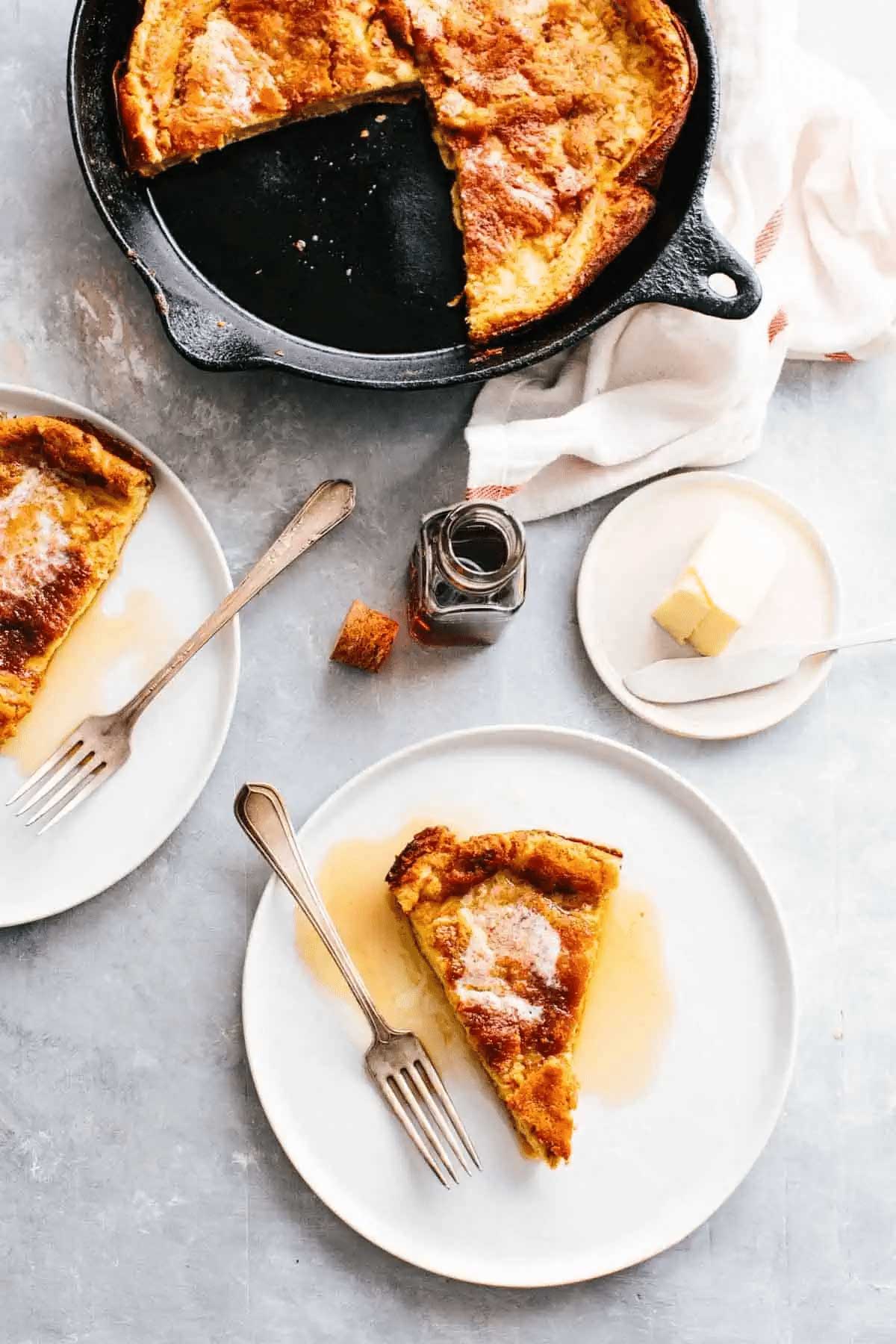 Serving a Dutch baby pancake on small plate. 