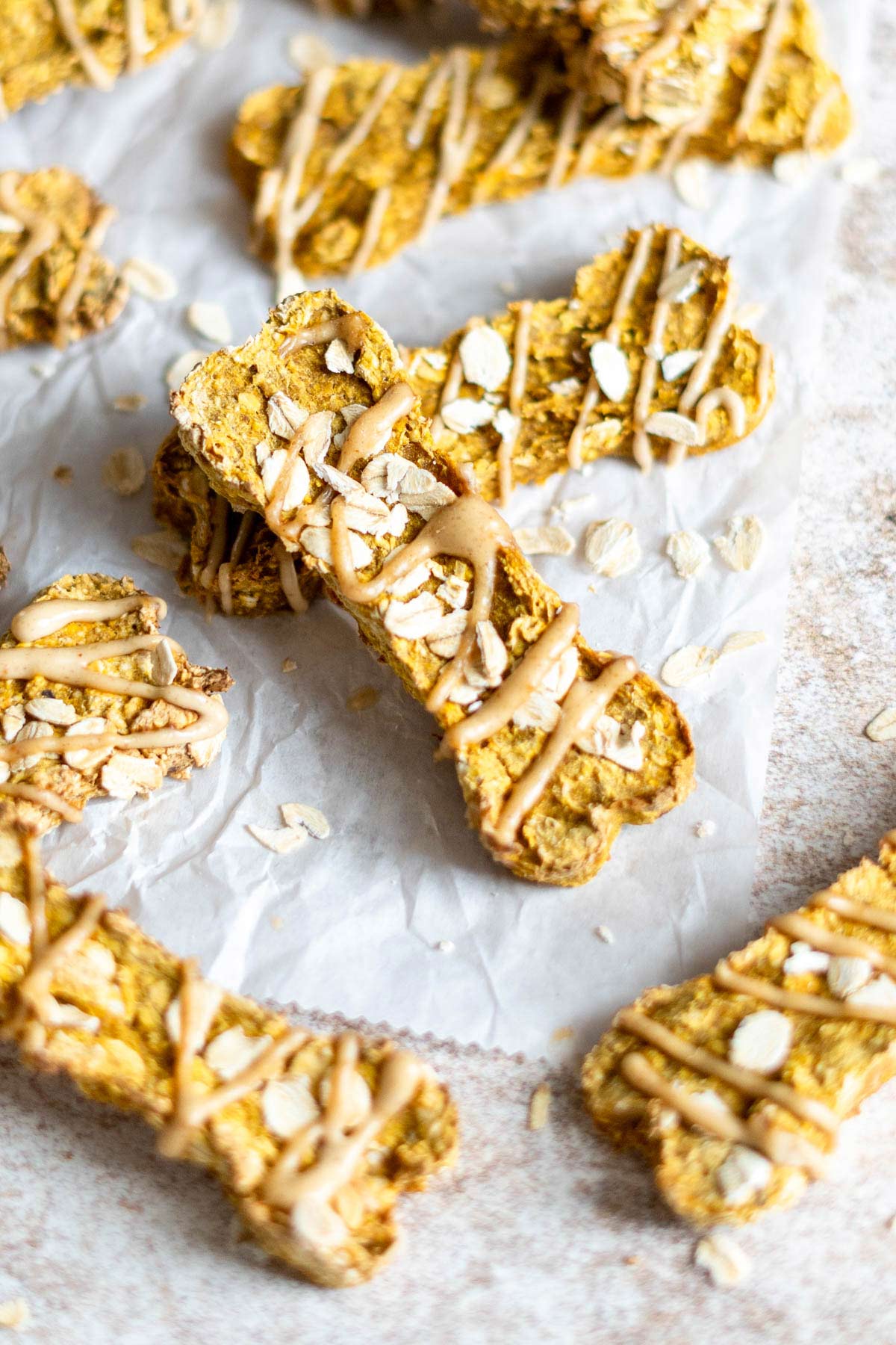 Homemade dog treats with rolled oats on parchment.