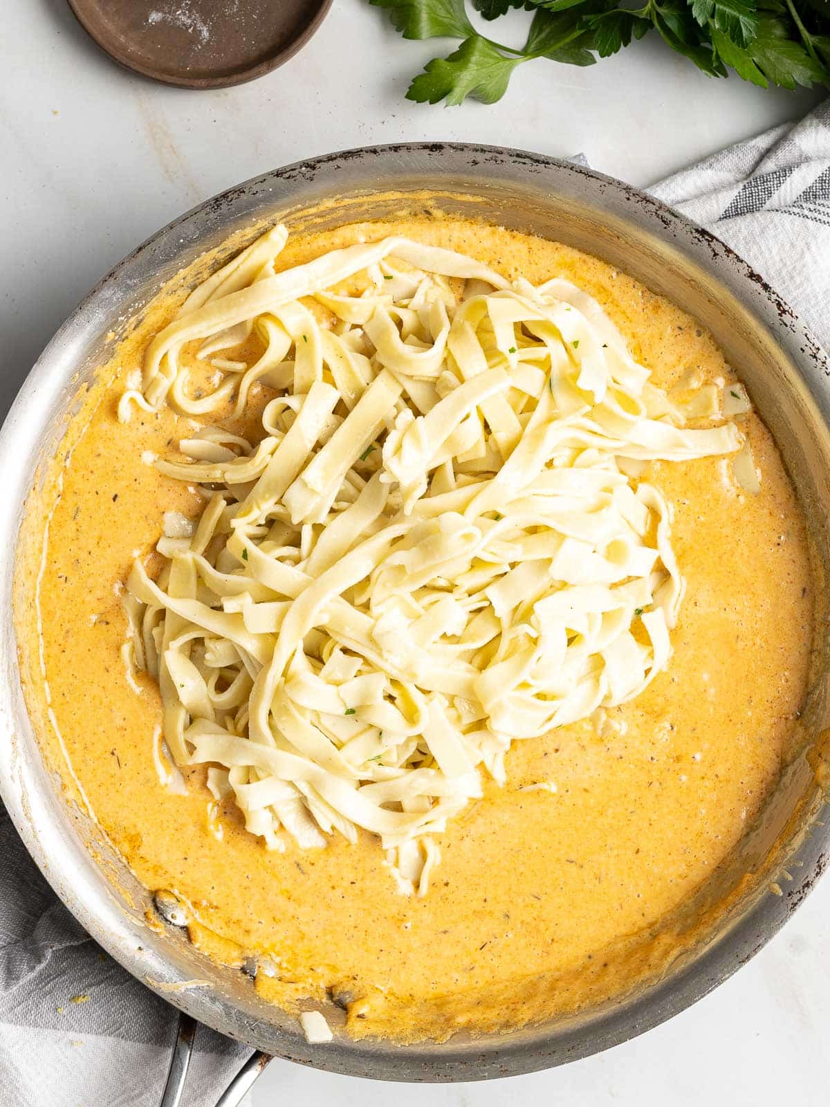 Pasta with spicy Cajun alfredo sauce in a pot.